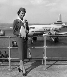 Dorothy Franklin posing in front of a TWA Airplane